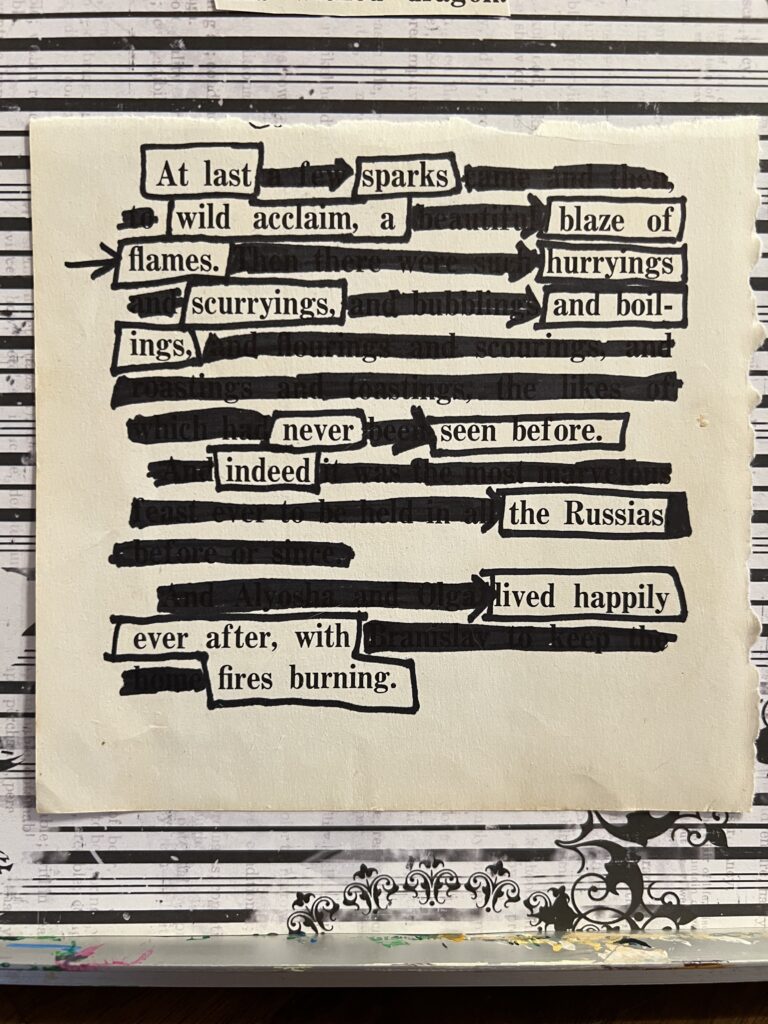 Close up of blackout poetry section that starts "At last sparks".